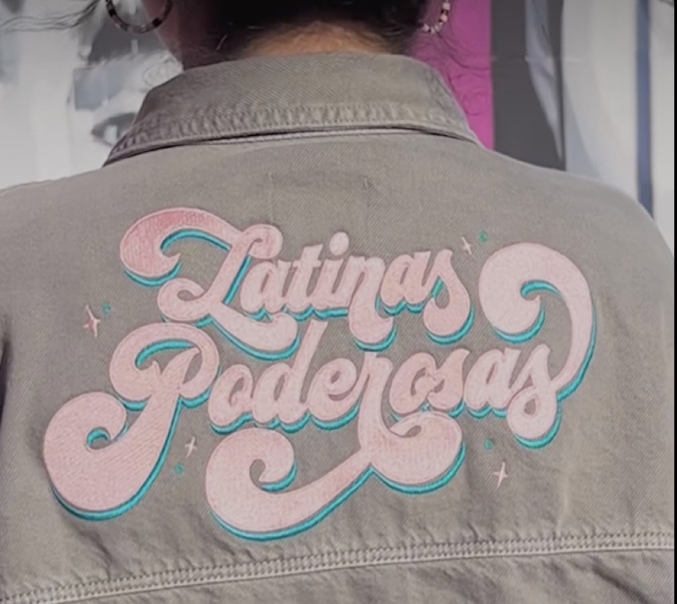 Latinas Poderosas wearing a custom embroidered jacket by JTEES